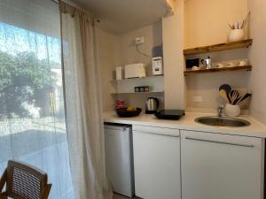 a small kitchen with a sink and a window at Apartment La casa di Manu by Interhome in Porto Maurizio