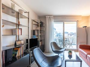 a living room with two chairs and a table and a couch at Apartment Le Galion-2 by Interhome in Dinard