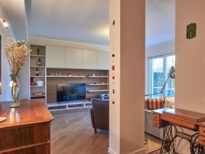 a kitchen and living room with a table and a couch at Apartment Promessi Sposi by Interhome in Lecco