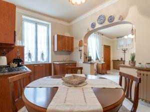 a kitchen with a wooden table and a dining room at Holiday Home Margherita by Interhome in Dolceacqua