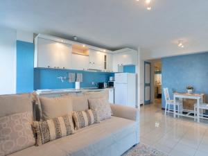 a living room with a couch and a kitchen at Apartment Mare Blu by Interhome in Cervo