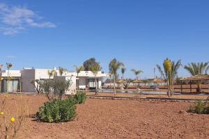 a desert area with buildings and trees and plants at Villa Marrakech in Marrakesh