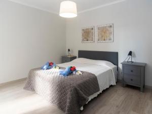 a bedroom with a bed with two stuffed animals on it at Apartment Olivais by Interhome in Lisbon