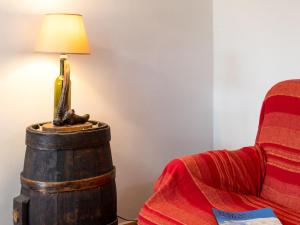 a lamp on top of a barrel next to a chair at Holiday Home Casa Mario by Interhome in Greve in Chianti