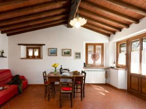 a living room with a table and chairs and a couch at Holiday Home Casa Mario by Interhome in Greve in Chianti