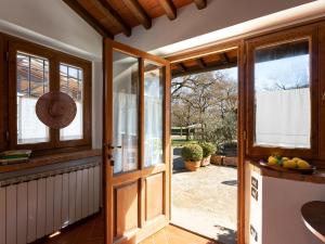 an open door to a kitchen with a patio at Holiday Home Casa Mario by Interhome in Greve in Chianti +22 photos