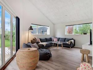 a living room with a couch and a table at Holiday Home Dorthie - 800m from the sea by Interhome in Hornbæk