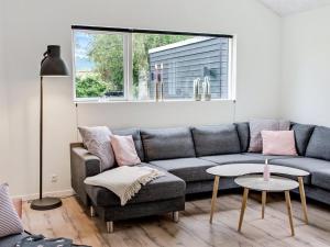 a living room with a couch and a table at Holiday Home Dorthie - 800m from the sea by Interhome in Hornbæk