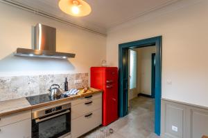 a kitchen with a red refrigerator in a room at Le Garage, Le Gite in Fontevraud-l'Abbaye +11 photos