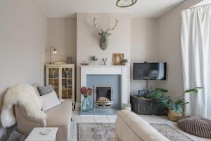 a living room with a couch and a fireplace at The House in Deal in Deal