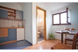 a kitchen and a dining room with a table at Apartments Mirko in Seget Vranjica