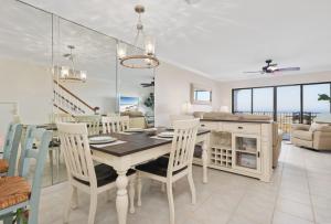 a dining room and living room with a table and chairs at Sea Place 11211 in Butler Beach