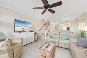 a living room with two couches and a flat screen tv at Sea Place 11211 in Butler Beach