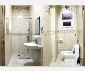 a bathroom with a toilet and a sink and a mirror at Roza Hotel Apartments in Muscat