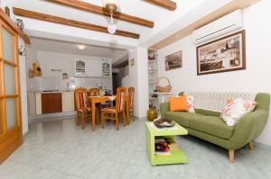 a living room with a green couch and a table at House Petric in Bol