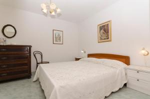 a bedroom with a bed and a dresser and a mirror at House Petric in Bol