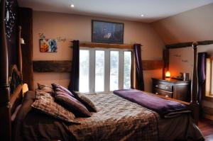 a bedroom with a bed and a large window at Five Star Ranch in Milton