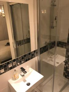 a bathroom with a shower and a sink and a mirror at Atlanta in Eastbourne