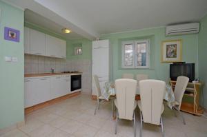 a kitchen with a table and chairs in a kitchen at House Marija in Lastovo