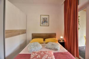 a bedroom with a bed with two pillows on it at Apartments Maja in Štinjan