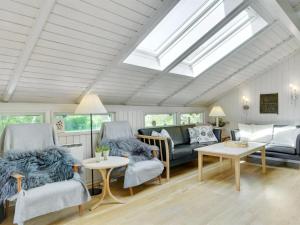 uma sala de estar com duas cadeiras e um sofá em Holiday Home Begitta - 350m from the sea in Sealand by Interhome em Gilleleje