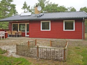 a red house with a fence in front of it at Holiday Home Jerk - 300m from the sea in Bornholm in Vester Sømarken