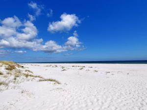 a sandy beach with a blue sky and clouds at Holiday Home Jerk - 300m from the sea in Bornholm in Vester Sømarken