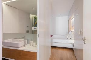 a bathroom with a sink and a mirror at Baía I by An Island Apart in Funchal +37 photos