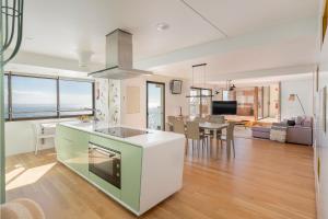 a kitchen and living room with a view of the ocean at Baía I by An Island Apart in Funchal