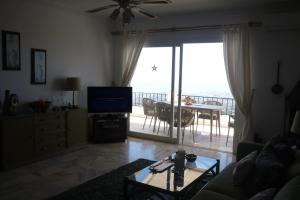 A television and/or entertainment centre at Stunning Views Mirador de Mijas Apt