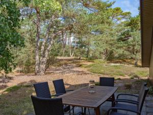 a wooden table and chairs on a patio at Holiday Home Heilo - 500m from the sea in Bornholm in Vester Sømarken
