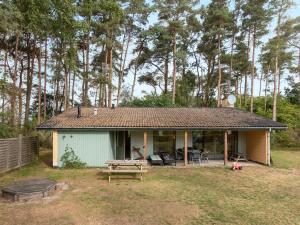 a small house with a picnic table in the yard at Holiday Home Henri - 800m from the sea in Bornholm by Interhome in Neksø +16 photos