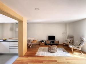 a kitchen and living room with a table and chairs at FX City Lover by LovelyStay in Funchal