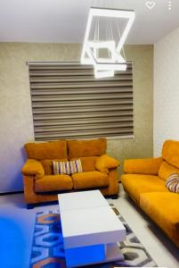 a living room with a couch and a table at SO CHIC APPARTEMENT Airport international Rabat-Salé in Salé
