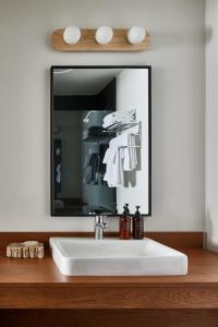 a bathroom with a white sink and a mirror at Bluebird Lake Placid in Lake Placid