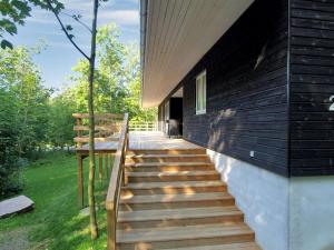 a house with wooden stairs on the side of a building at Holiday Home Lätizia - 300m from the sea by Interhome in Svaneke