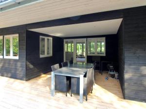 a dining room with a table and chairs at Holiday Home Lätizia - 300m from the sea by Interhome in Svaneke +16 photos