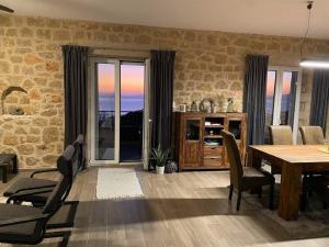 a dining room with a table and chairs with a view at Rapunzel's Tower Mani in Neokhórion
