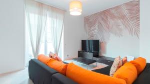 a living room with a couch with orange pillows at Italianway - Brianza 14 A in Milan