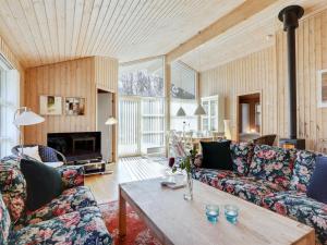 a living room with two couches and a table at Holiday Home Sakarias - 800m from the sea by Interhome in Hasle