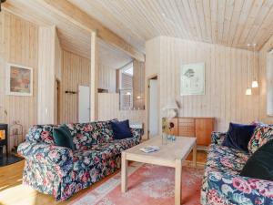 a living room with two couches and a table at Holiday Home Sakarias - 800m from the sea by Interhome in Hasle