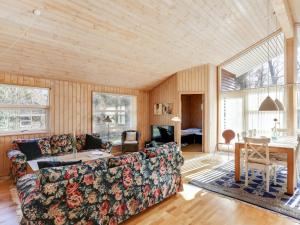 a living room with a couch and a table at Holiday Home Sakarias - 800m from the sea by Interhome in Hasle