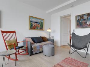 a living room with a couch and two chairs at Apartment Reinhardt - 100m from the sea in Bornholm by Interhome in Allinge