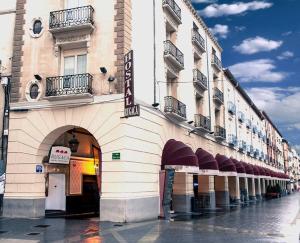 a building with a sign on the side of it at Hostal Rugaca in Huesca