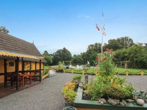 a garden with a building with a flag on it at Apartment Syzett - 250m from the sea by Interhome in Neksø