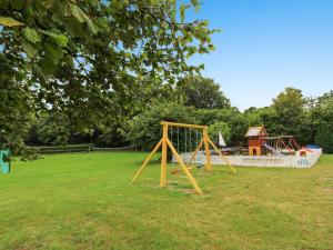a park with a swing set in the grass at Apartment Syzett - 250m from the sea by Interhome in Neksø