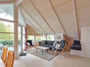 a living room with a couch and chairs at Holiday Home Dagmar - 300m from the sea in Bornholm by Interhome in Hasle