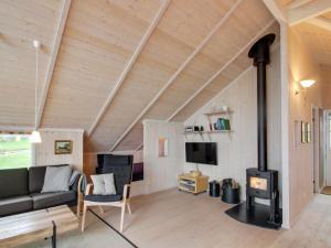 a living room with a wood stove in a house at Holiday Home Dagmar - 300m from the sea in Bornholm by Interhome in Hasle
