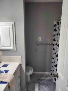 a bathroom with a toilet and a shower at Lovely Condo on the Water in Kemah