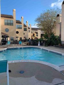 a large swimming pool in front of a building at Lovely Condo on the Water in Kemah